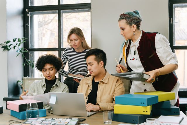 A group of diverse professionals collaborating in a bright, modern office setting