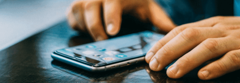 A person is scrolling through his phone