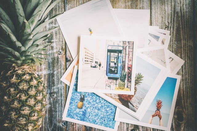 Assorted Photo Beside Pineapple on Top of Brown Surface.jpg