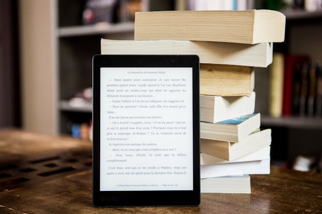 Black Tablet Computer Behind Books.jpg