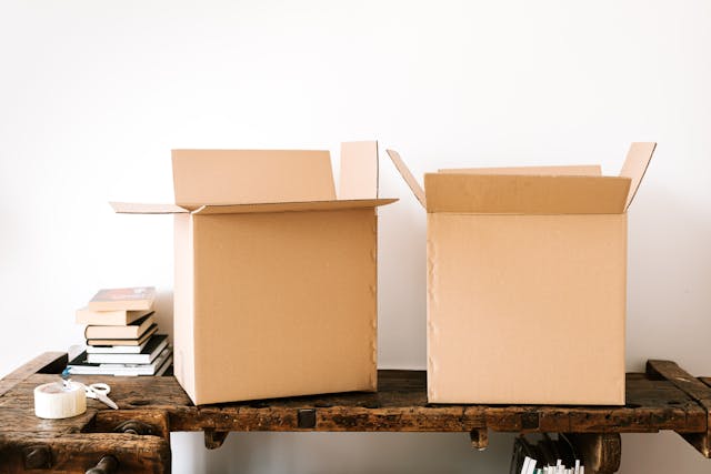 Carton boxes and stacked books on table.jpg