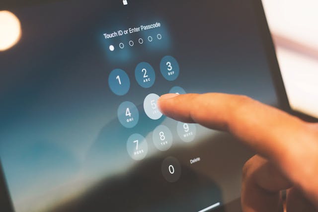 Close-up of a finger entering a passcode