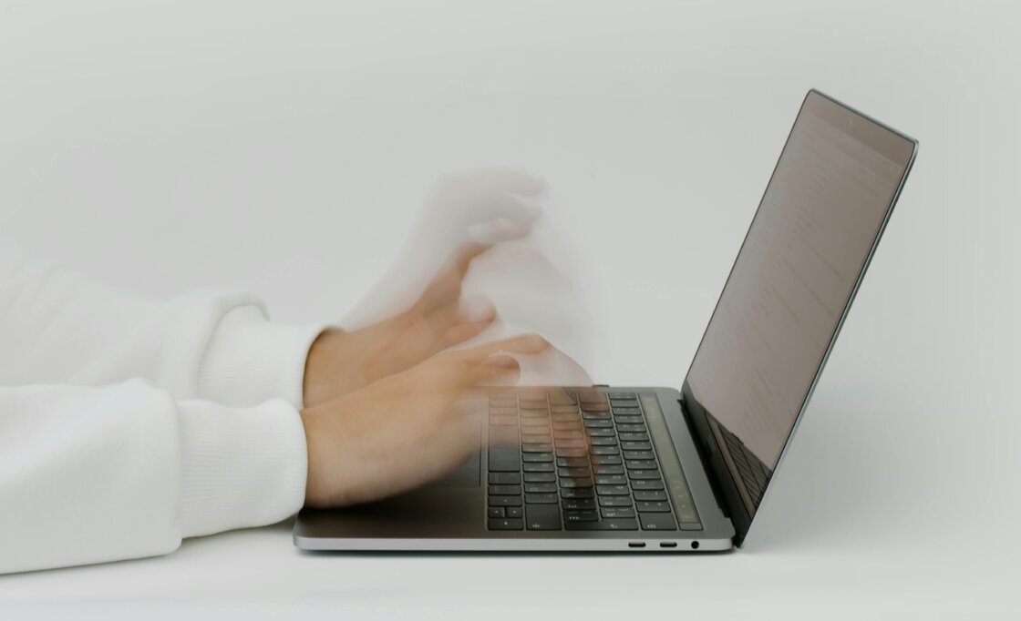 A person typing on laptop