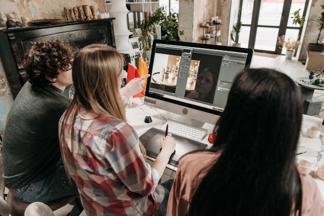 People Sitting and Working in front of a Desktop Computer