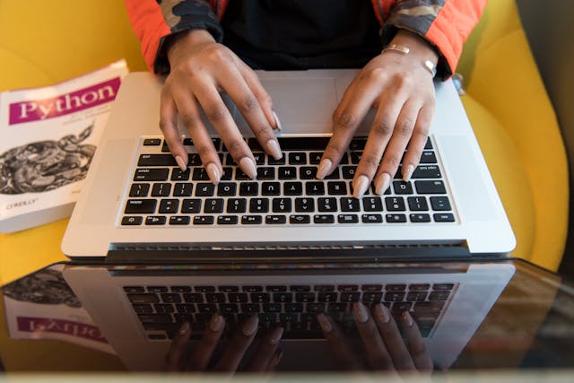 Person Typing On Macbook Pro