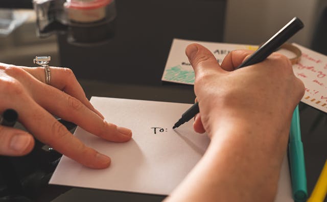 Person Writing on White Paper