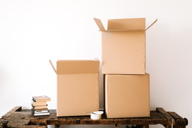 Stack of carton boxes and books on shabby table.jpg