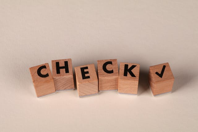 Wooden Blocks Spelling 'Check' with Checkmark.jpg