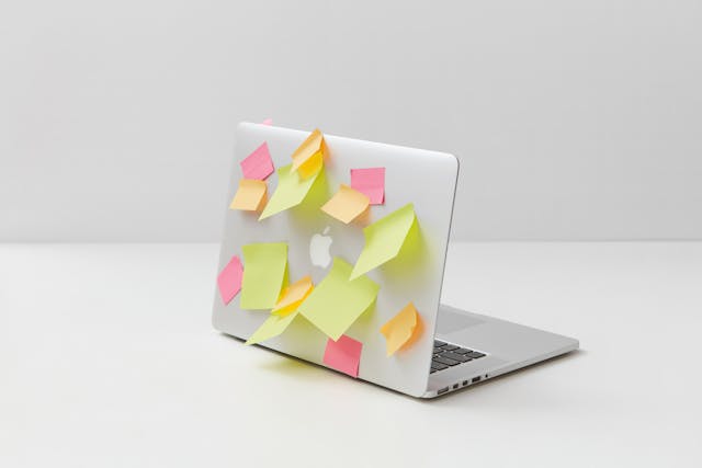 Yellow Green and Pink Sticky Notes on Silver Laptop.jpg