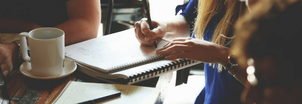 A woman is writting in her notebook.png