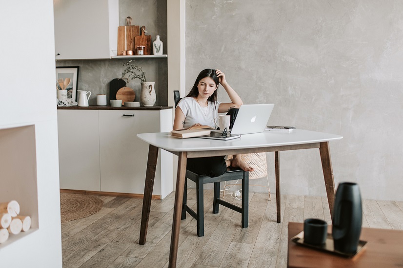 focused-young-woman-with-laptop-and-books-at-home-4050326.jpg