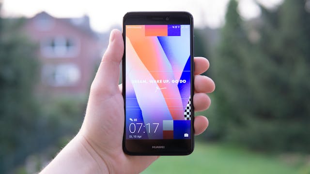 A person holding a Huawei mobile phone