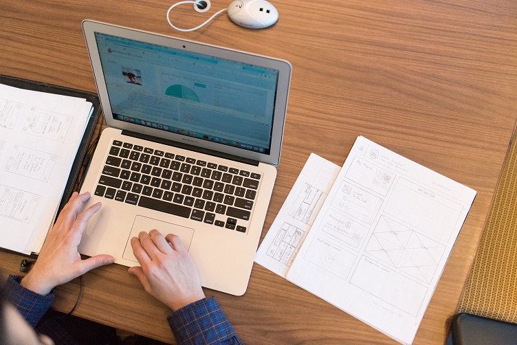 Person's hands on top of macbook air