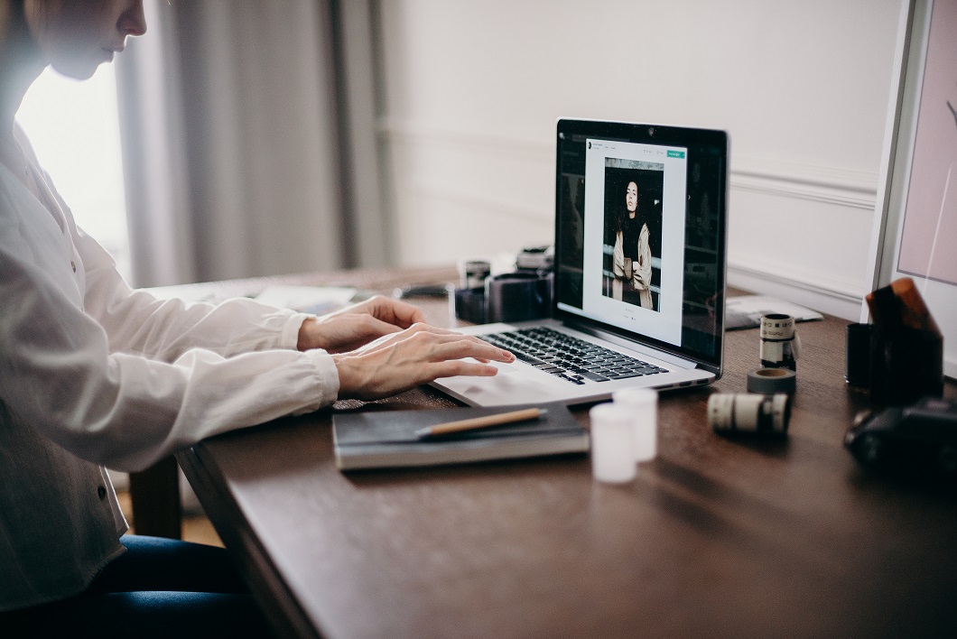 Selective focus photography of woman using macbook pro